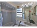 Bathroom featuring a shower-tub, a vanity with a mirror and decorative lighting at 22115 Laver Ln, Land O Lakes, FL 34639