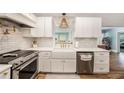 Modern kitchen with white cabinetry, stainless steel appliances, and farmhouse sink at 2353 Dora Dr, Clearwater, FL 33765