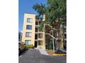 View of the building exterior with stairs and parking area, showcasing its design and accessibility at 2424 W Tampa Bay Blvd # M-201, Tampa, FL 33607