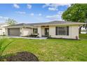 Beautiful single-story home with updated landscaping, new roof, and lake view at 3205 Pleasant Lake Dr, Tampa, FL 33618