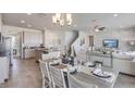 Open-concept living area featuring a dining space and a modern kitchen, great for entertaining at 32442 Osprey Peak Way, San Antonio, FL 33576