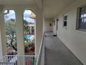 Exterior hallway overlooking the community pool and lush landscaping at 3850 13Th N Ave # 311, St Petersburg, FL 33713