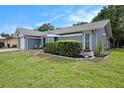 Charming single-story home featuring a well-maintained lawn, attached garage, and manicured hedges at 4326 Great Lakes N Dr, Clearwater, FL 33762