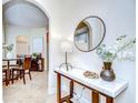 Stylish entryway with a marble table and view of the dining area at 4968 Anniston Cir, Tampa, FL 33647