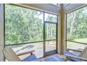 Relaxing screened-in patio with comfortable seating and serene views at 4968 Anniston Cir, Tampa, FL 33647