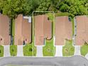 Aerial view of the home showcasing its position among neighboring properties and surrounding greenery at 521 Bent Oak Ct, Spring Hill, FL 34609