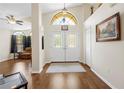 Elegant foyer showcasing double doors, hardwood floors, and lots of natural light at 521 Bent Oak Ct, Spring Hill, FL 34609
