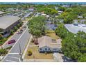An aerial view showcases this cozy residence nestled in a vibrant neighborhood close to local amenities and waterfront views at 556 Virginia St, Dunedin, FL 34698