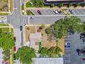 Overhead view of the property shows its location near parking, mature trees, and vibrant community amenities at 556 Virginia St, Dunedin, FL 34698