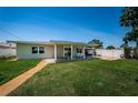 Well-manicured backyard featuring a covered patio perfect for outdoor entertaining at 5785 15Th N Ave, St Petersburg, FL 33710