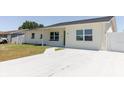 A newly poured concrete driveway leading to a freshly painted charming one-story home at 6110 16Th St, Zephyrhills, FL 33542