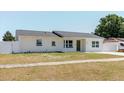 Charming one-story home with a well-manicured lawn, freshly painted exterior, and a new roof at 6110 16Th St, Zephyrhills, FL 33542