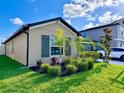 Lovely home with lush landscaping, showcasing vibrant green lawn and colorful plants at 7114 Fern Garden Ct, Sun City Center, FL 33573