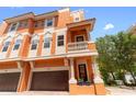 Beautiful three story home featuring balconies, columns, and a two-car garage at 904 Villa Venicia Way, Tampa, FL 33606