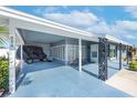 Covered carport area with seating, featuring attractive decorative column accents at 906 Hacienda Dr, Sun City Center, FL 33573