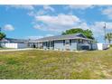 Side view of a well-maintained home, showcasing its clean lines and tidy landscaping at 906 Hacienda Dr, Sun City Center, FL 33573