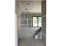 Spacious living room featuring unfinished drywall and ample natural light, awaiting your personal design and finishing touches at 1435 17Th N Ave, St Petersburg, FL 33704
