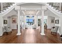 Elegant foyer with grand staircase, gleaming hardwood floors, and breathtaking lake views beyond at 17124 Crawley Rd, Odessa, FL 33556