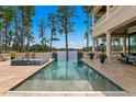 Inviting in-ground pool overlooking a serene lake view, perfect for relaxation and entertainment at 17124 Crawley Rd, Odessa, FL 33556