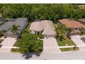 An aerial view of a beautiful single-story home with a three-car garage, pool and screened-in patio at 17318 Emerald Chase Dr, Tampa, FL 33647