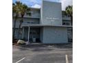 Exterior view of Shore Manor featuring palm trees and an awning over the entrance at 1898 Shore S Dr # 311, South Pasadena, FL 33707