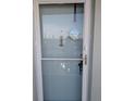 Close-up of the unit's front door, with welcome decor, and peephole at 1898 Shore S Dr # 311, South Pasadena, FL 33707