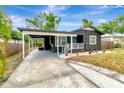 Inviting single-story home, complemented by a covered parking area and manicured landscape at 1914 E Emma St, Tampa, FL 33610