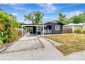 Cozy home showcasing a covered parking area and inviting front entrance at 1914 E Emma St, Tampa, FL 33610