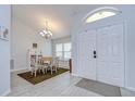 Inviting dining area with a decorative chandelier, next to the entrance, showcasing a bright and airy atmosphere at 2020 Elk Spring Dr, Brandon, FL 33511