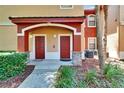 A welcoming townhome exterior featuring covered entries and neat landscaping at 2220 Chianti Pl # 8-0828, Palm Harbor, FL 34683