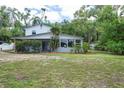 Home exterior with a lush lawn, mature trees and a white picket fence at 2814 W Humphrey St, Tampa, FL 33614