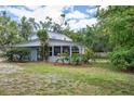 Exterior view of home, featuring a well-maintained lawn and mature trees at 2814 W Humphrey St, Tampa, FL 33614