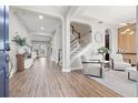 Bright foyer features wood floors, a staircase, and elegant decor creating a welcoming entrance at 32122 Wenlock Loop, Wesley Chapel, FL 33543