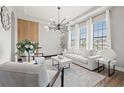 Stylish living room with modern furniture, a decorative wall, and plenty of natural light at 32122 Wenlock Loop, Wesley Chapel, FL 33543