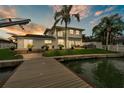 Waterfront property featuring a dock, patio, and outdoor seating, perfect for enjoying waterfront living at 330 Palm Ne Is, Clearwater Beach, FL 33767