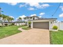 Beautiful two-story home showcasing a well-manicured lawn, and a two-car garage at 330 Palm Ne Is, Clearwater Beach, FL 33767