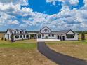 Majestic exterior showcasing the property's expansive land, and modern farmhouse architecture at 3515 Powerline Rd, Lithia, FL 33547
