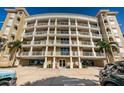 Beautiful building boasts multi-story balconies supported by white pillars at 3805 Gulf Blvd # 504, St Pete Beach, FL 33706
