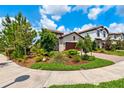Single-story home with a brick driveway, manicured landscaping, and inviting curb appeal at 3877 Burdick Loop, Odessa, FL 33556