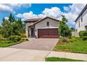 Charming single-story home with a beautiful paver driveway and manicured landscaping at 3877 Burdick Loop, Odessa, FL 33556
