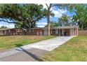 Charming single-story brick home with a spacious driveway and mature shade trees at 4512 24Th Ave S, Tampa, FL 33619