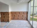 In-progress interior space with exposed walls and large glass sliding door leading to a patio at 4885 1St Ne St # 110, St Petersburg, FL 33703