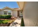 Inviting front entrance with a glass storm door and mature landscaping at 5242 Venice Ne Way, St Petersburg, FL 33703