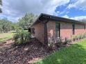 All brick single story home with a well-manicured lawn and landscape at 6533 Brentwood Dr, Zephyrhills, FL 33542
