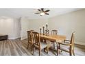 Inviting dining area features wood table and chairs, stylish light fixture and light, neutral color palette at 6703 Towhe Dr, Seffner, FL 33584