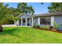 Charming home exterior features a well-kept lawn and beautiful landscaping at 8307 Boxwood Dr, Tampa, FL 33615