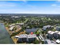 Scenic aerial view of condo building with water view, and community amenities, Sarasota, Florida at 100 Oakmont Ln # 305, Belleair, FL 33756