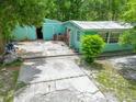 Driveway leading up to a single-story home, focusing on its outdoor access and potential at 10854 Telford St, New Port Richey, FL 34654