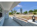 The home has a cozy front porch with gray brick and a clear view of the street at 10900 Queens Rd, Port Richey, FL 34668