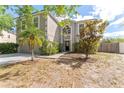 Two-story home features lush landscaping, a palm tree, and a modern exterior at 10930 Banyan Wood Way, Riverview, FL 33579